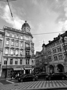 A black and white photo of a street corner

Description automatically generated