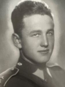 A person in uniform smiling

Description automatically generated