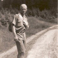 A person walking on a dirt road

Description automatically generated