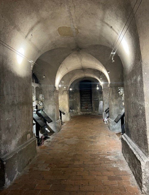 A stone hallway with a brick floor

Description automatically generated